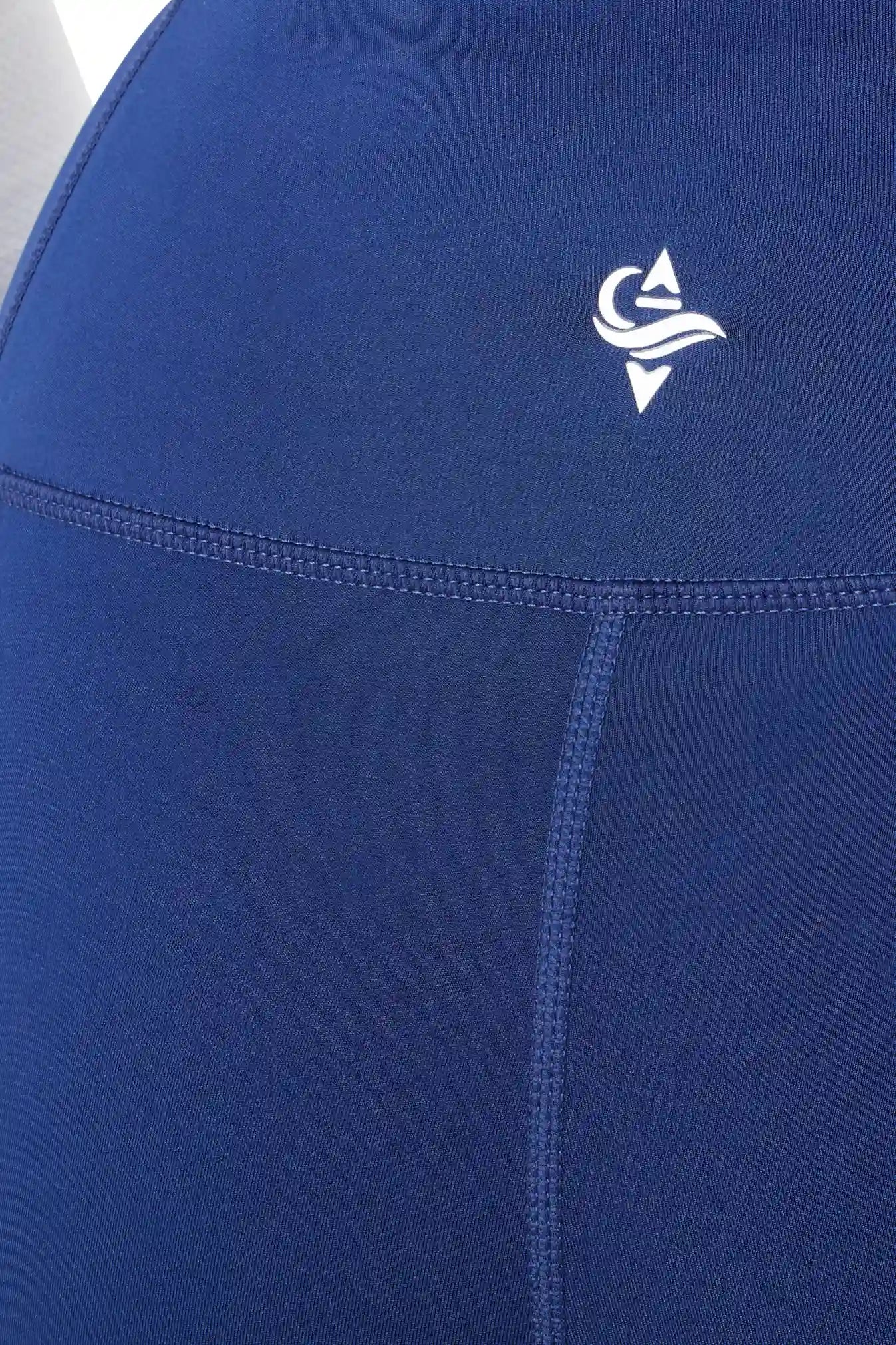 Close-up of blue athletic leggings with IROW logo on the waistband.