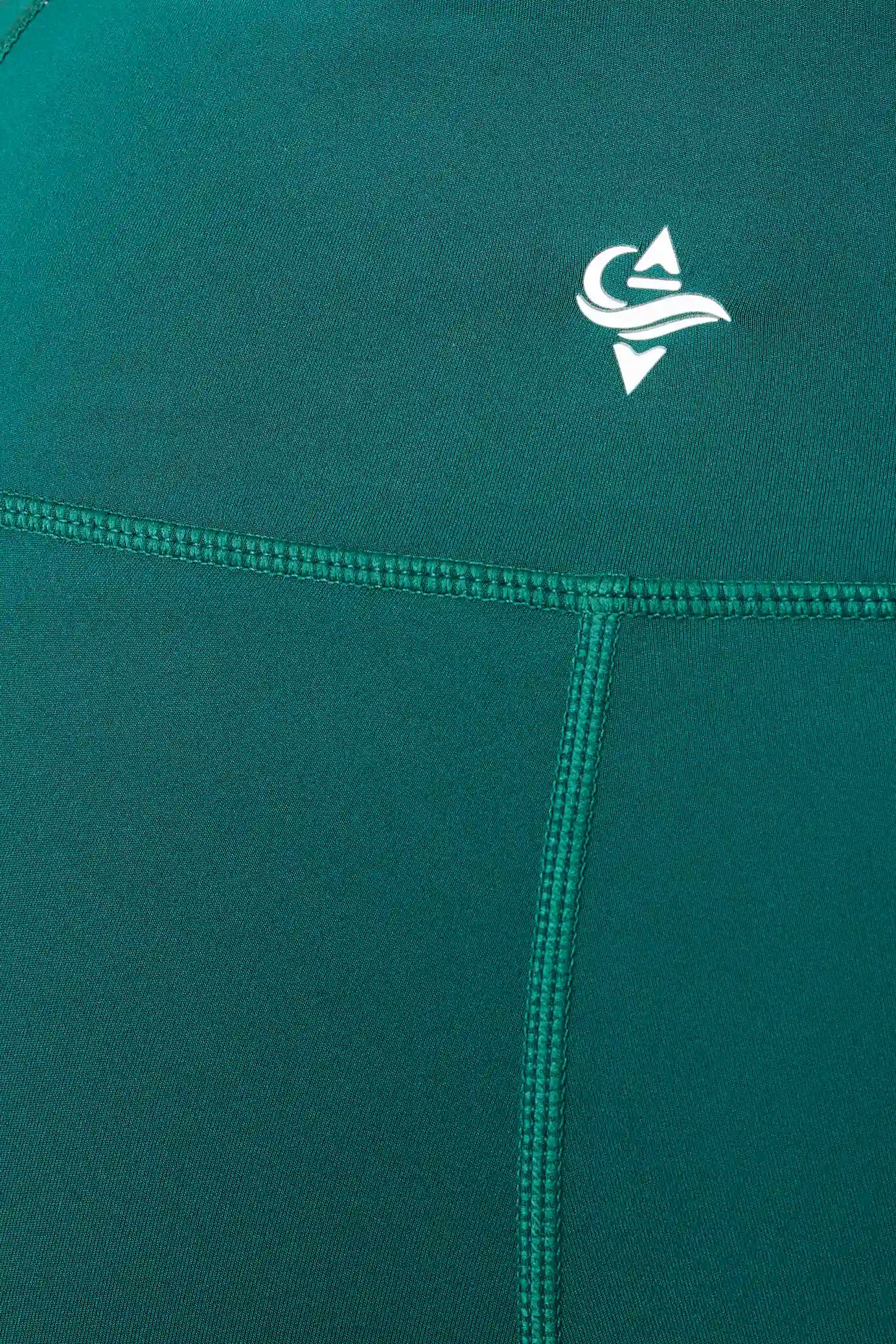 Teal fabric with a white IROW logo on a close-up of a garment