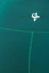 Teal fabric with a white IROW logo on a close-up of a garment